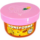 A honey slime container with the lid closed, showcasing magical honey and clay slime qualities with Cornwithslime logo on the lid.